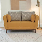 Homecrest modern 2-seater sofa in mustard fabric with patterned back cushions and solid wood base in a living room