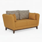 Homecrest modern 2-seater sofa in mustard fabric with patterned back cushions and curved armrests on a wood base.