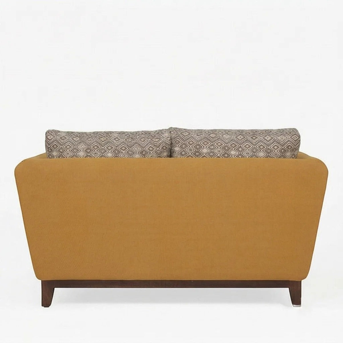 Homecrest 2-seater sofa in mustard fabric with a solid wood base and patterned back cushions, back view.