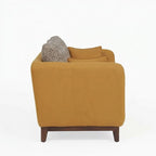 Homecrest 2-seater sofa in mustard fabric with curved armrests, solid wood base, and patterned back cushions.