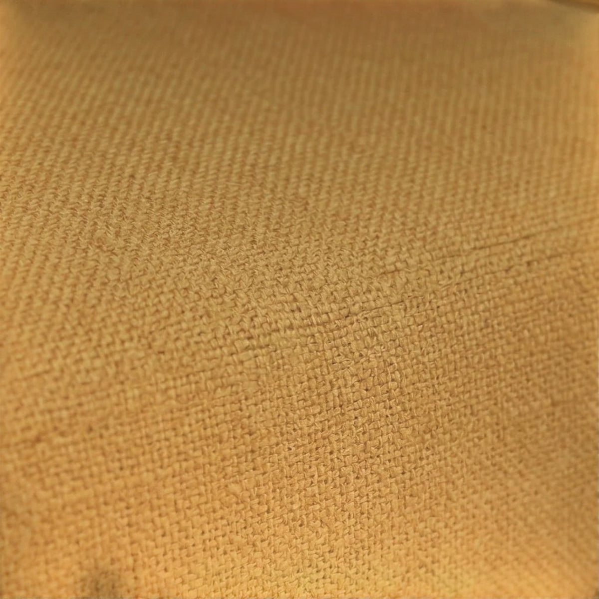 Close-up of the textured mustard yellow fabric upholstery on a Homecrest 2-seater sofa