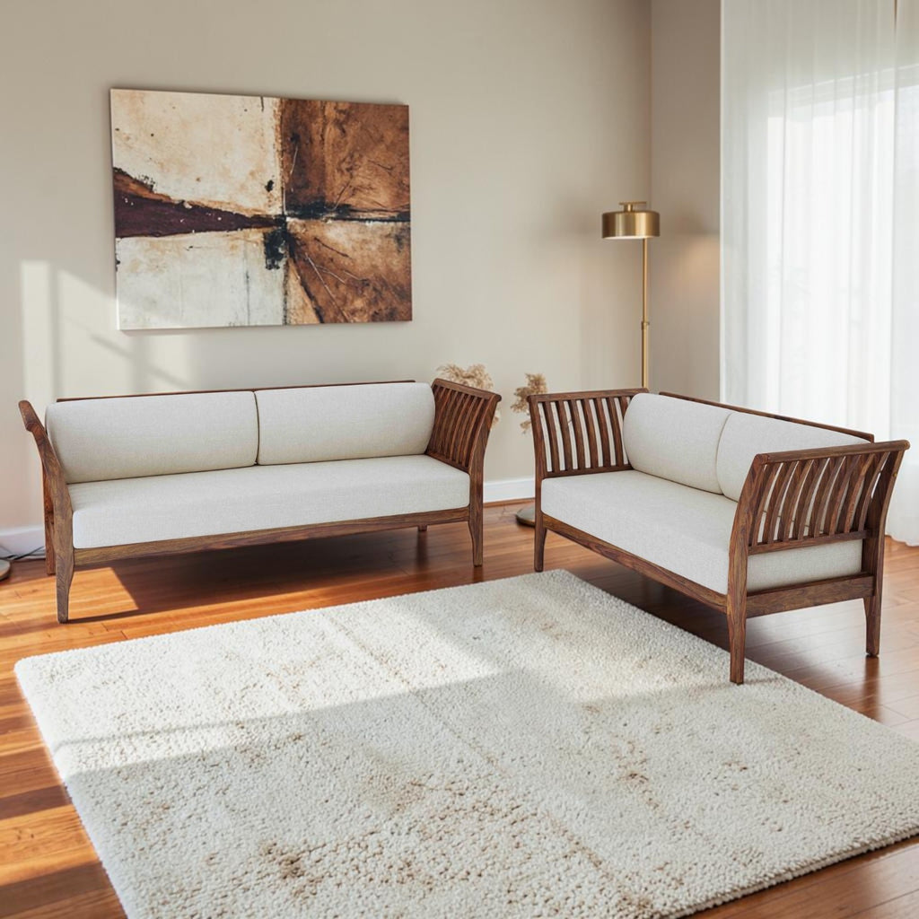 Homecrest Naunton sheesham wood sofa set with teak finish and cream upholstered cushions in a modern living room.