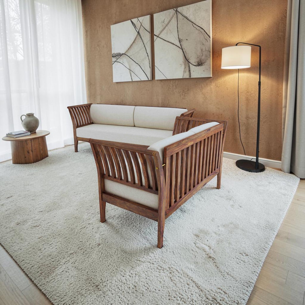 Homecrest Naunton sofa set in teak finish sheesham wood with cream upholstered cushions in a modern living room.