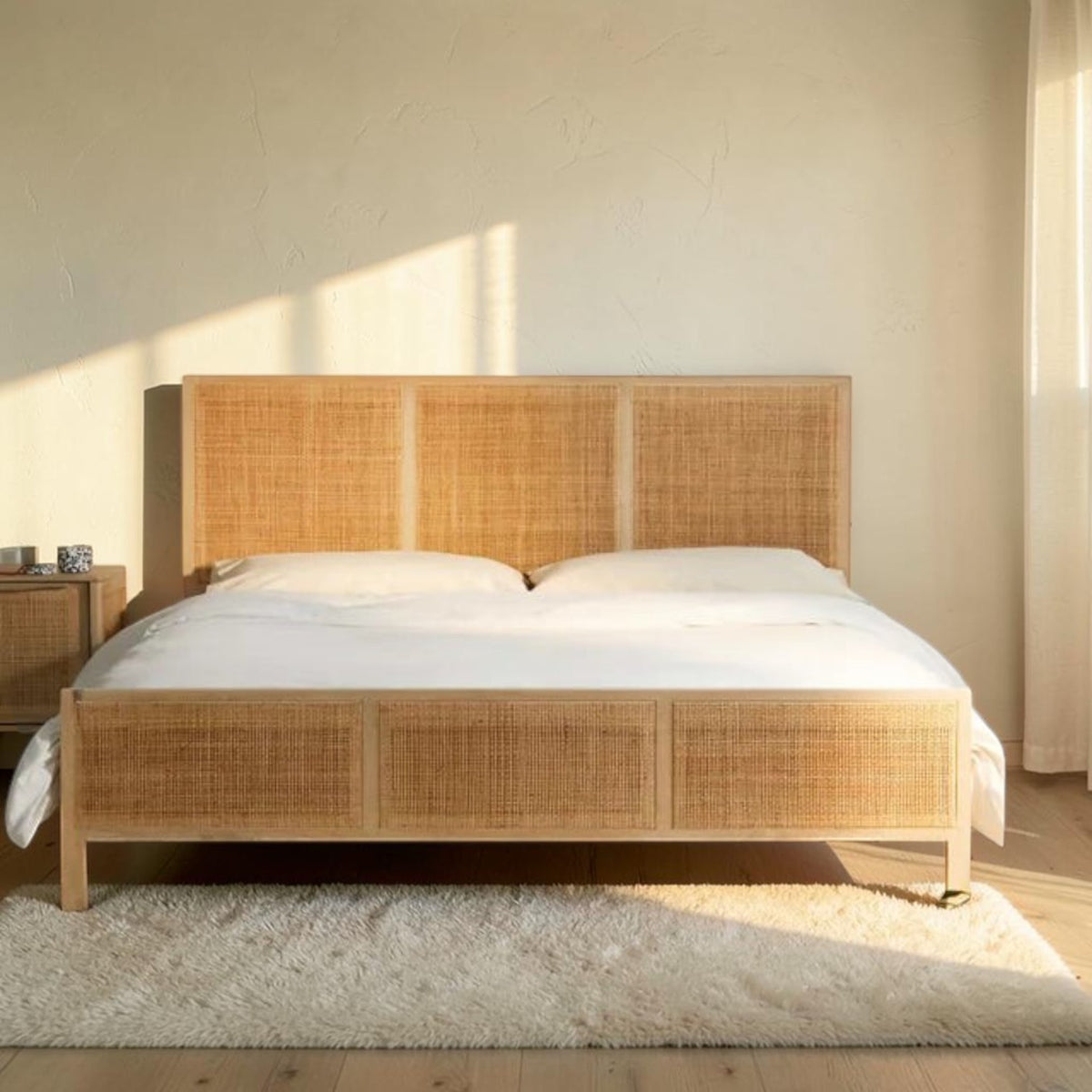 Homecrest natural mango wood bed frame with a woven rattan headboard and footboard in a sunlit bedroom setting