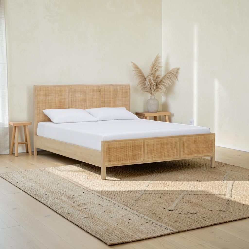 Homecrest natural mango wood bed frame with a woven rattan headboard and footboard in a bright minimalist bedroom