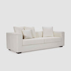 Homecrest Nesta low-profile deep-seat sofa in cream fabric with broad arms and matching decorative cushions