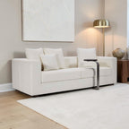 Homecrest Nesta low-profile cream sofa with deep seating, broad arms, and decorative cushions in a modern living room.