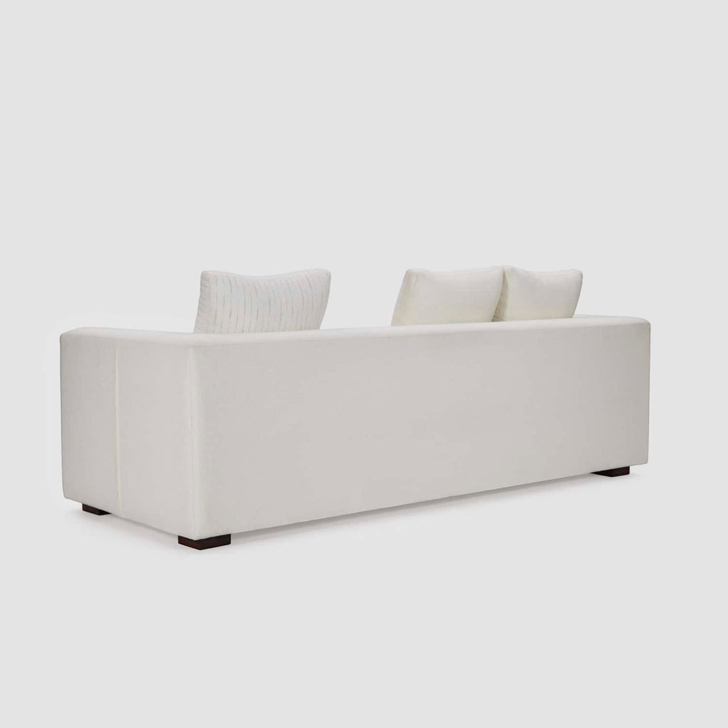 Homecrest Nesta low-profile deep-seat sofa in cream upholstery, viewed from the back showing broad flat arms.