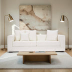 Homecrest Nesta low-profile white deep-seat sofa with broad arms and decorative cushions in a modern living room.