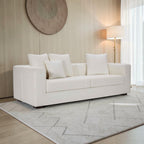 Homecrest Nesta low-profile white deep-seat sofa with broad arms and decorative throw pillows in a modern living room.