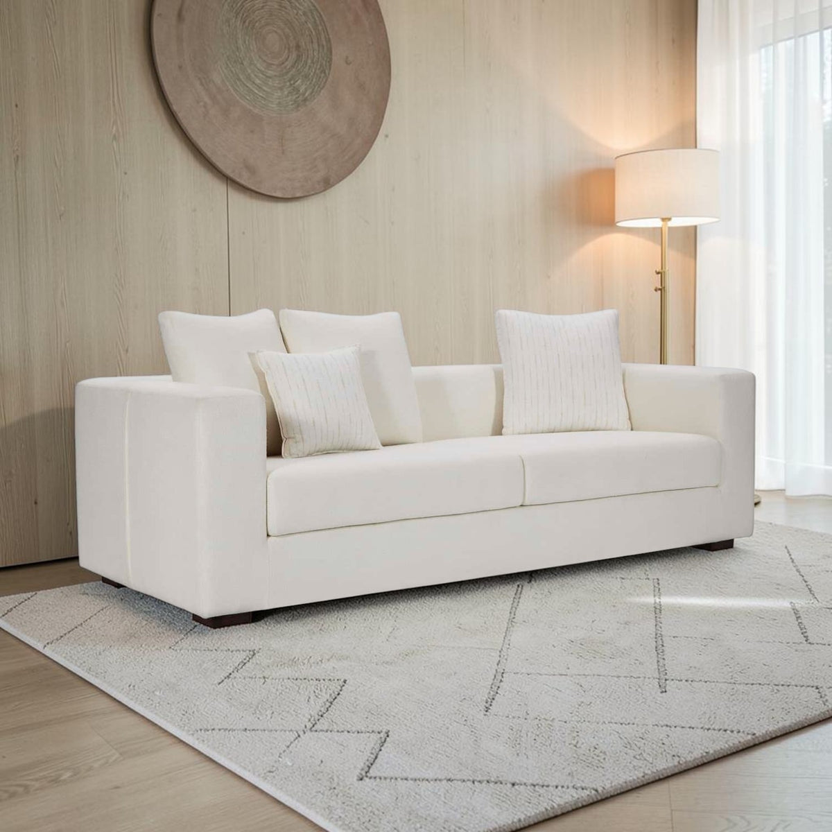 Homecrest Nesta low-profile white deep-seat sofa with broad arms and decorative throw pillows in a modern living room.