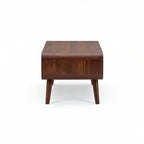 Homecrest Nyle mid-century coffee table in solid wood with rounded edges and angled legs, front view.