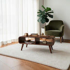 Homecrest Nyle mid-century modern solid wood coffee table with rounded edges, dual open shelves, and angled legs.