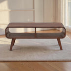 Homecrest Nyle mid-century modern solid wood coffee table with rounded edges, open shelving, and angled legs.
