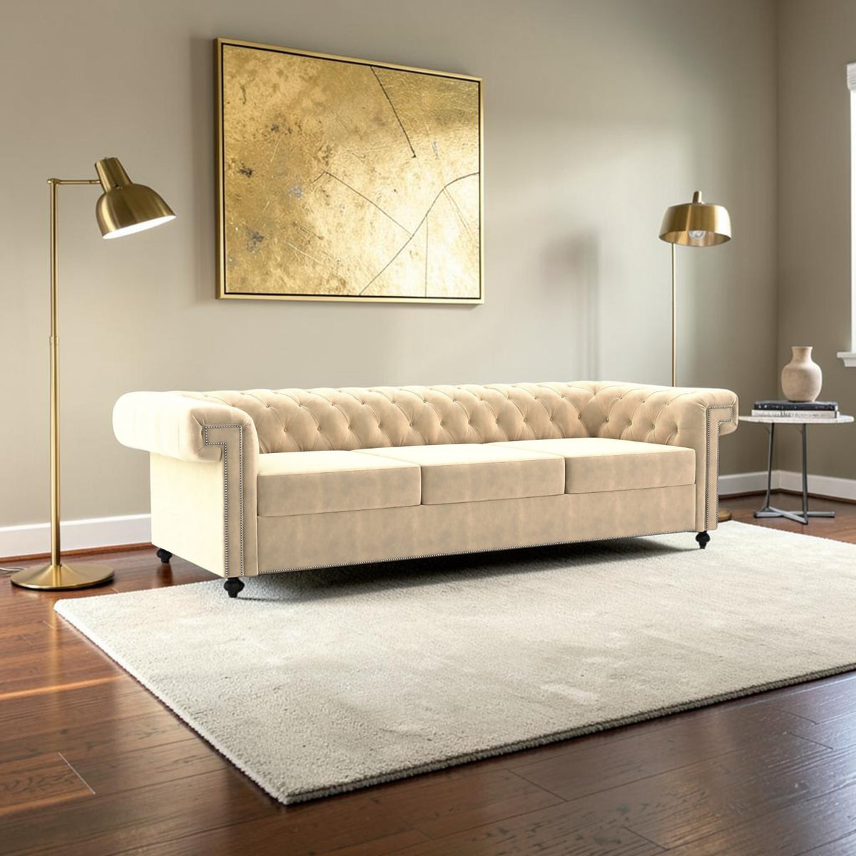 Homecrest Oakley three-seater Chesterfield sofa in beige velvet with tufted back and nailhead trim in a modern room.
