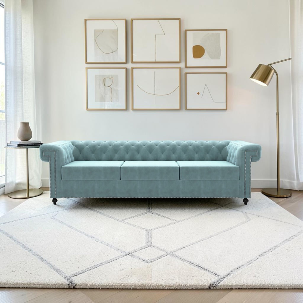 Homecrest Oakley Chesterfield sofa in light blue velvet with button tufting and nailhead trim in a modern living room.