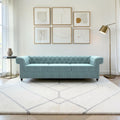 Homecrest Oakley Chesterfield sofa in light blue velvet with button tufting and nailhead trim in a modern living room.