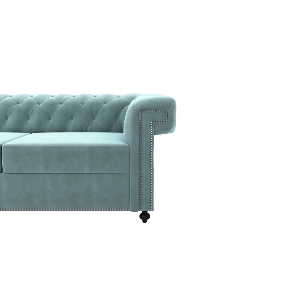Homecrest Oakley Chesterfield sofa in dusk blue velvet with tufted backrest and silver nailhead trim on the armrest.