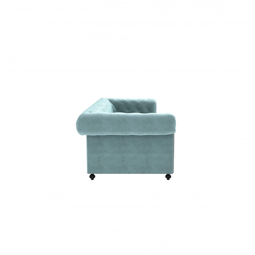 Homecrest Oakley Chesterfield sofa in dusk blue velvet with button tufting and rolled armrest, side view