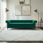 Homecrest Oakley emerald green velvet Chesterfield sofa with tufted back and nailhead trim in a modern living room