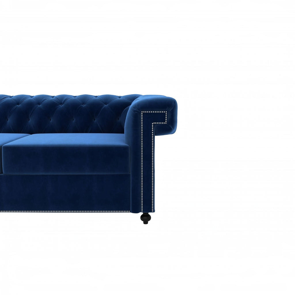 Homecrest Oakley Chesterfield sofa in indigo blue velvet with tufted backrest and silver nailhead trim detail.