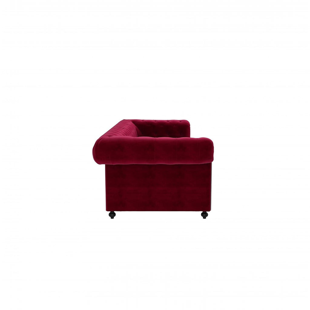 Homecrest Oakley Chesterfield sofa in pomegranate red velvet with tufted detailing, side view