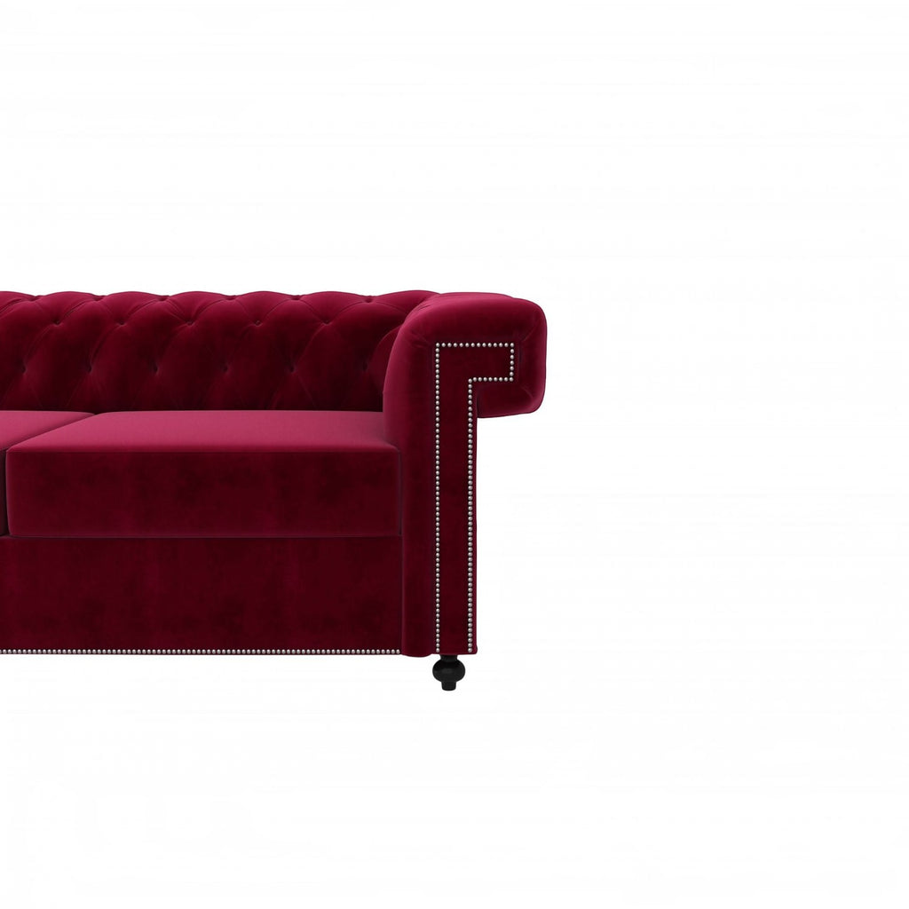 Homecrest Oakley Chesterfield sofa in pomegranate velvet with button tufting and silver nailhead trim on the armrest