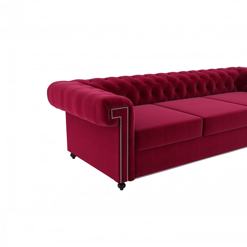 Homecrest Oakley Chesterfield sofa in pomegranate red velvet with tufted backrest and silver nailhead trim details.