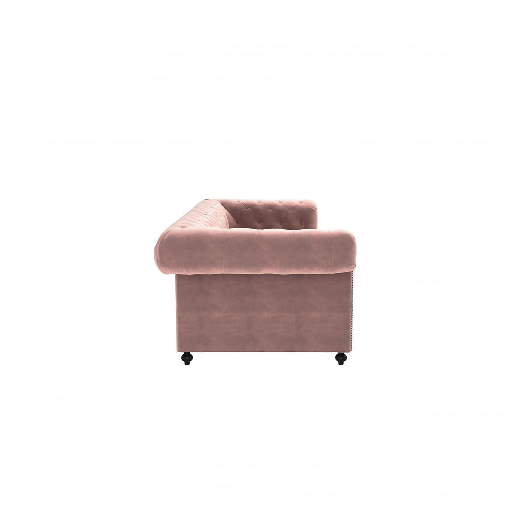 Homecrest Oakley Chesterfield sofa in rose dust velvet with tufted detailing and side view profile