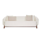 Homecrest Orbell wrap-arm curved sofa in cream fabric with sculptural teak wood legs and two decorative throw pillows.