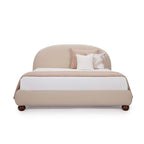 Homecrest Penhurst teakwood bed with a curved upholstered headboard and low profile frame in a neutral beige fabric.