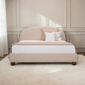 Homecrest Penhurst teakwood bed with a curved upholstered headboard and low profile frame in a neutral beige fabric.