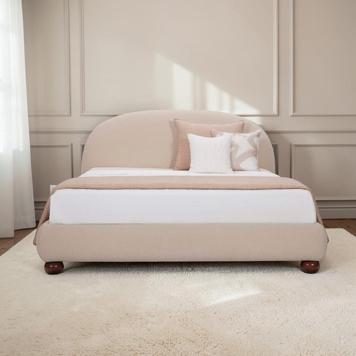 Homecrest Penhurst teakwood bed with a curved upholstered headboard and low profile frame in a neutral beige fabric.