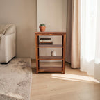 Homecrest Perrin compact bookshelf in solid sheesham wood with a natural teak finish and open storage shelves.