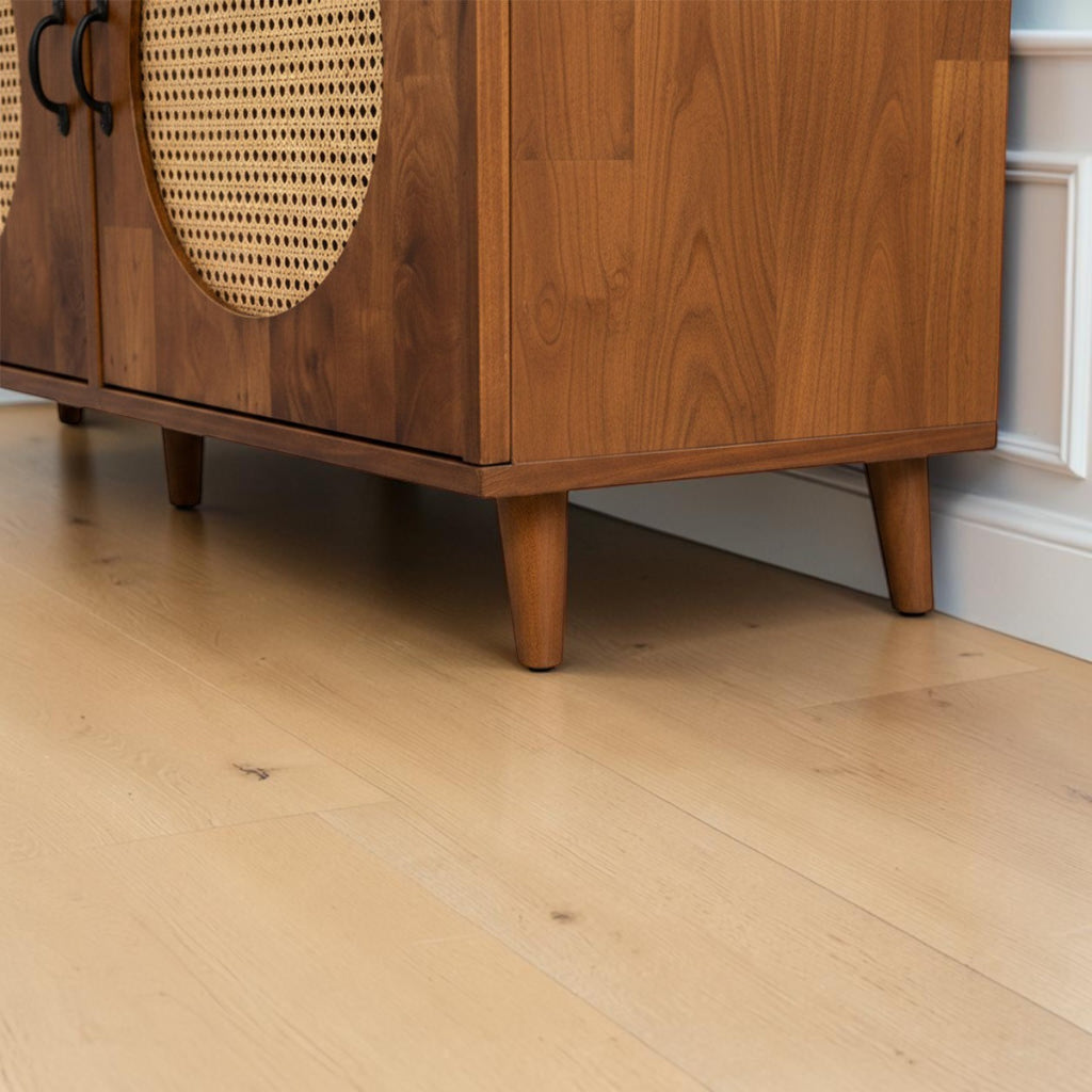 Homecrest Petra three-door media cabinet in honey-finished solid sheesham wood with circular cane rattan door inserts.