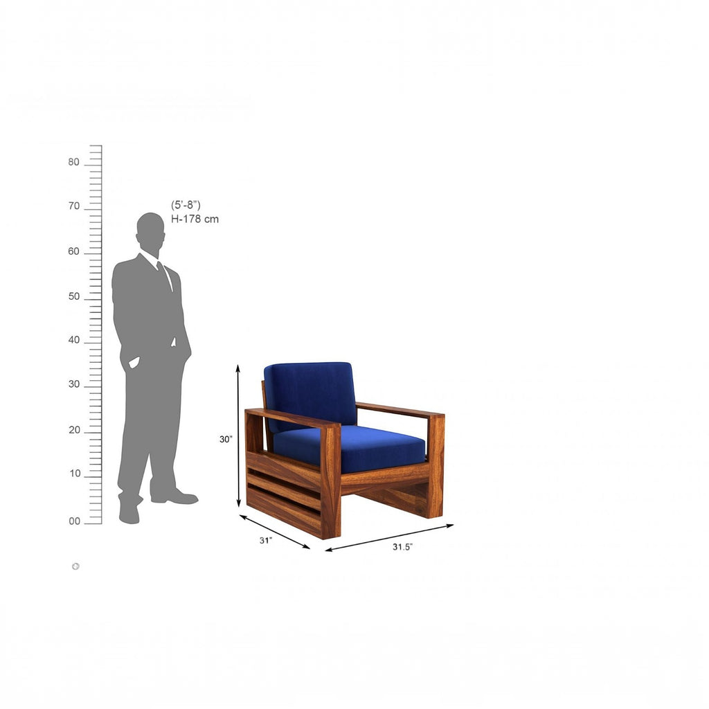 Homecrest Pilton wooden armchair with blue fabric cushions and a natural sheesham wood frame shown with scale reference