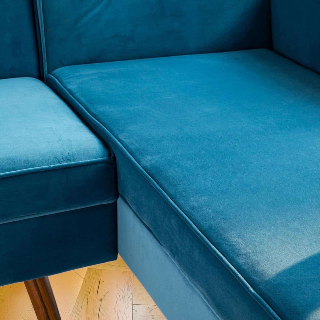 Homecrest Thurston sectional sofa in deep blue velvet upholstery with mid-century teak wood legs