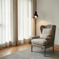 Homecrest Ridlington grey upholstered armchair with rattan side panels and solid wood frame in a bright living room