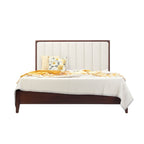 Homecrest Rushden teakwood bed featuring a tall cream upholstered paneled headboard and dark wood frame