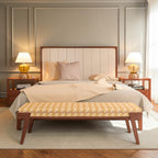 Homecrest Rushden teakwood king bed with a cream paneled upholstered headboard in a modern bedroom setting.