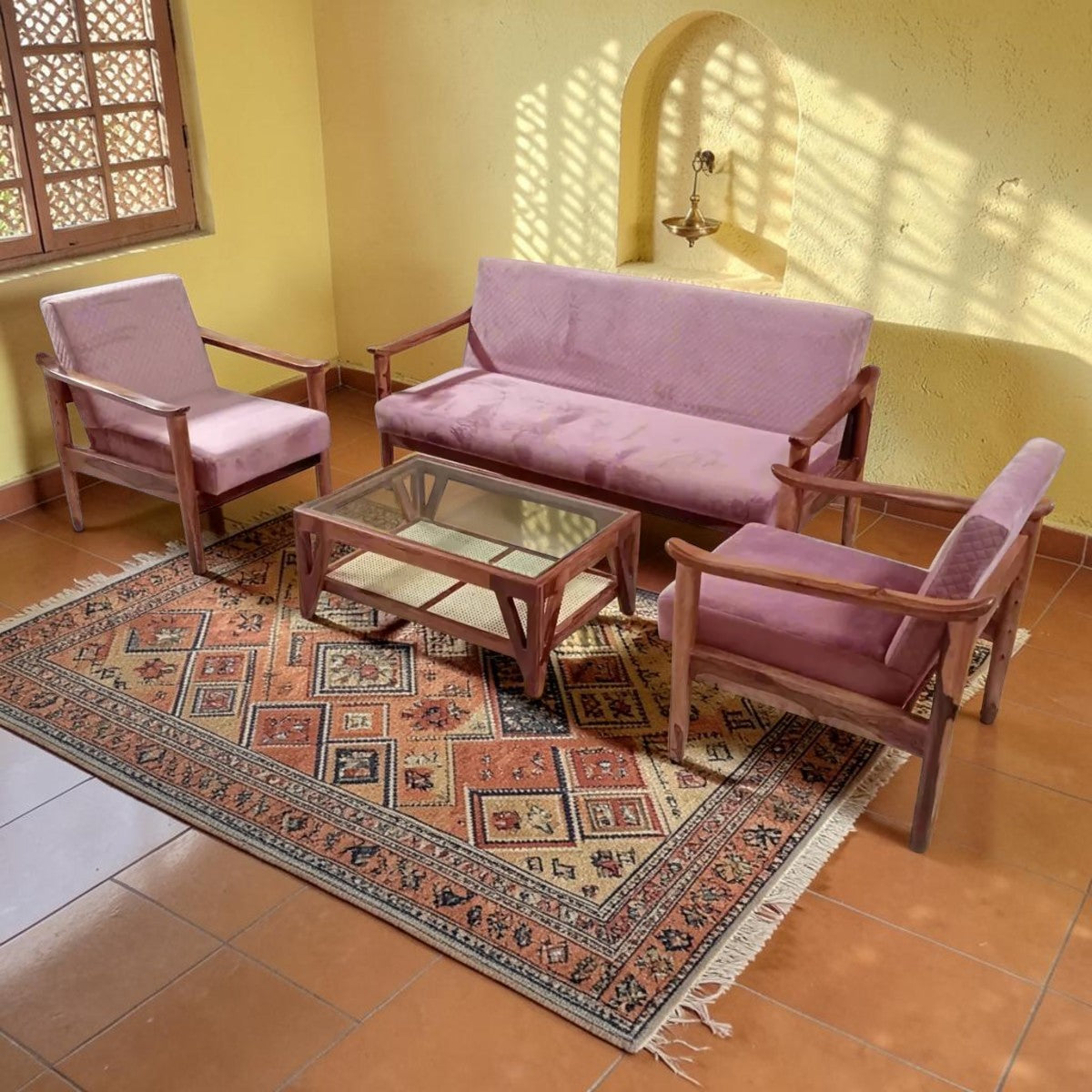 Homecrest Rose Sheesham wood sofa set with pink velvet upholstery, including a three-seater, two armchairs, and table.