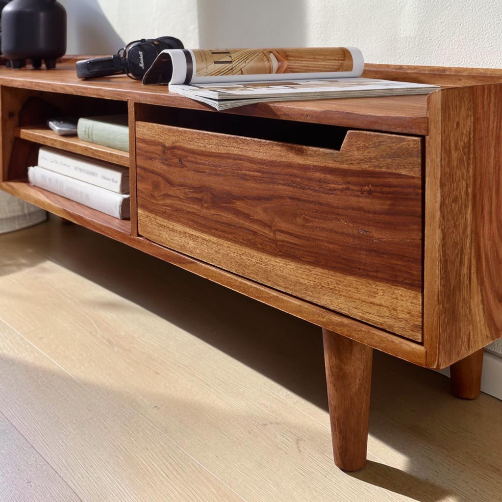 Homecrest Rowley solid wood media cabinet in a warm walnut finish with open shelving and a drawer