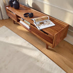 Homecrest Rowley solid wood media cabinet in a rich honey finish with open shelving and a low-profile design.