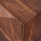 Homecrest Sabine media cabinet in walnut solid sheesham wood with detailed fluted door texture and sharp corner edge