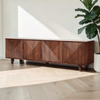 Homecrest Sabine media cabinet in solid sheesham wood with four fluted doors and gold-toned handles in a bright room.