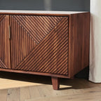 Homecrest Sabine media cabinet in walnut sheesham wood with fluted geometric door fronts and gold-toned handles.