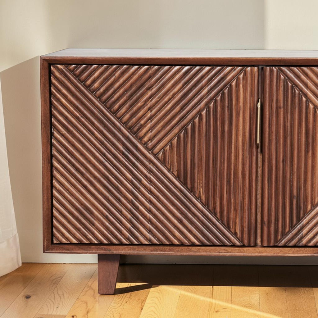 Homecrest Sabine media cabinet in walnut solid sheesham wood with fluted geometric door fronts and gold handles.