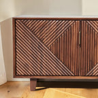 Homecrest Sabine media cabinet in walnut solid sheesham wood with fluted geometric door fronts and gold handles.