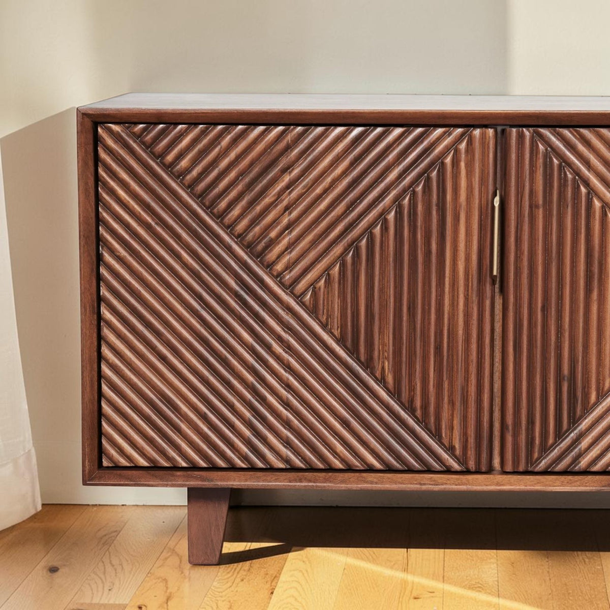 Homecrest Sabine media cabinet in walnut solid sheesham wood with fluted geometric door fronts and gold handles.
