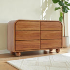 Homecrest Roswell 6-drawer dresser in warm brown acacia wood with rounded edges and spherical feet in a bright room.